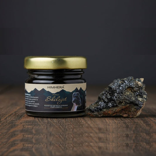Jar of Himhera Shilajit on a wooden surface with a dark background